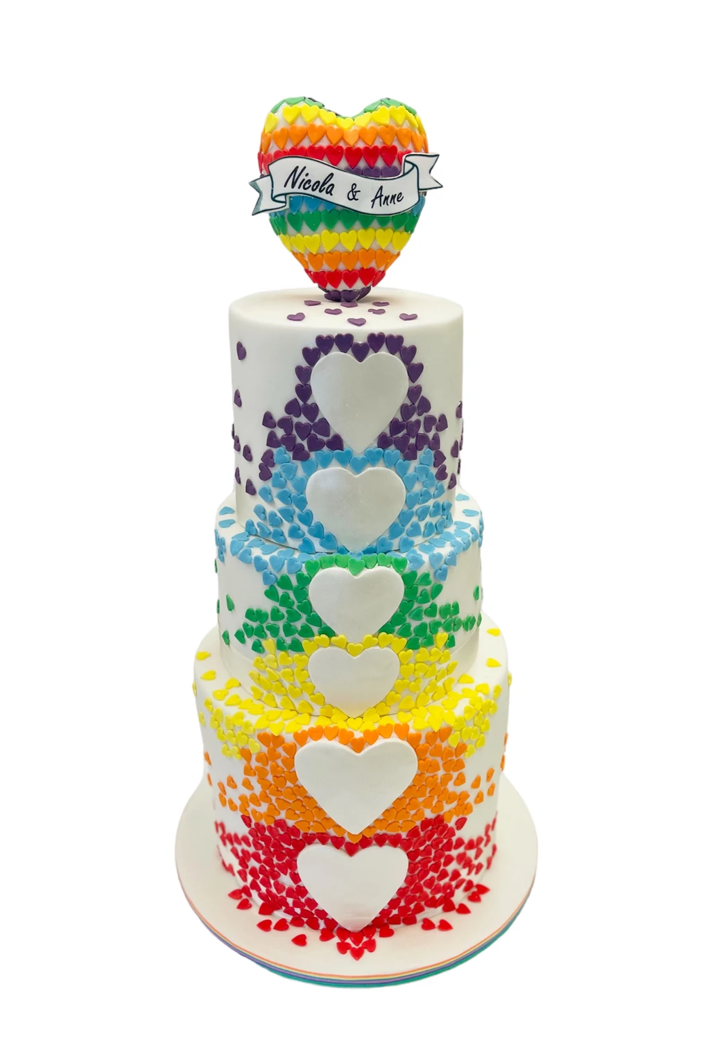 Rainbow heart cake with a colourful topper