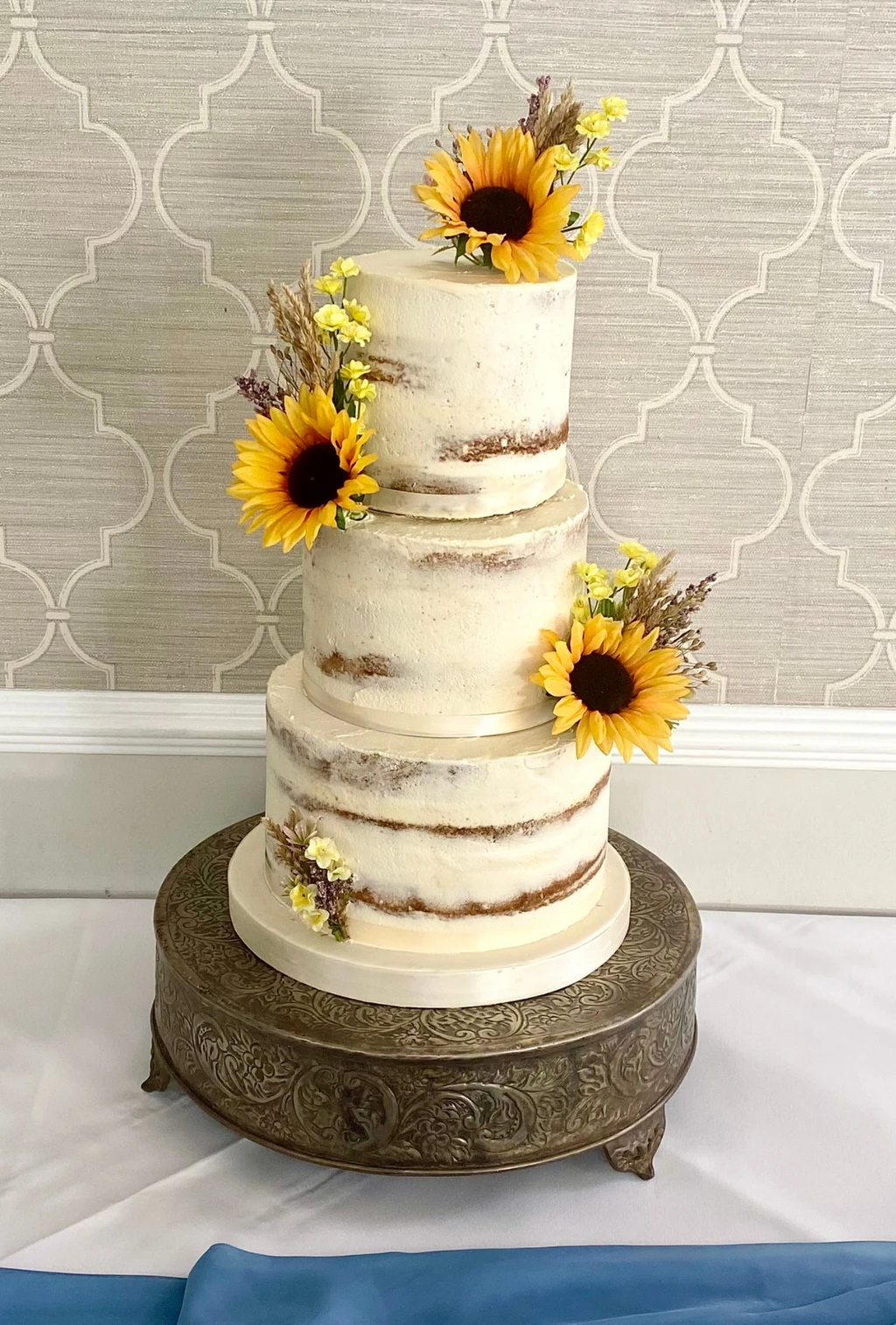 Three-tier semi-naked cake with sunflowers
