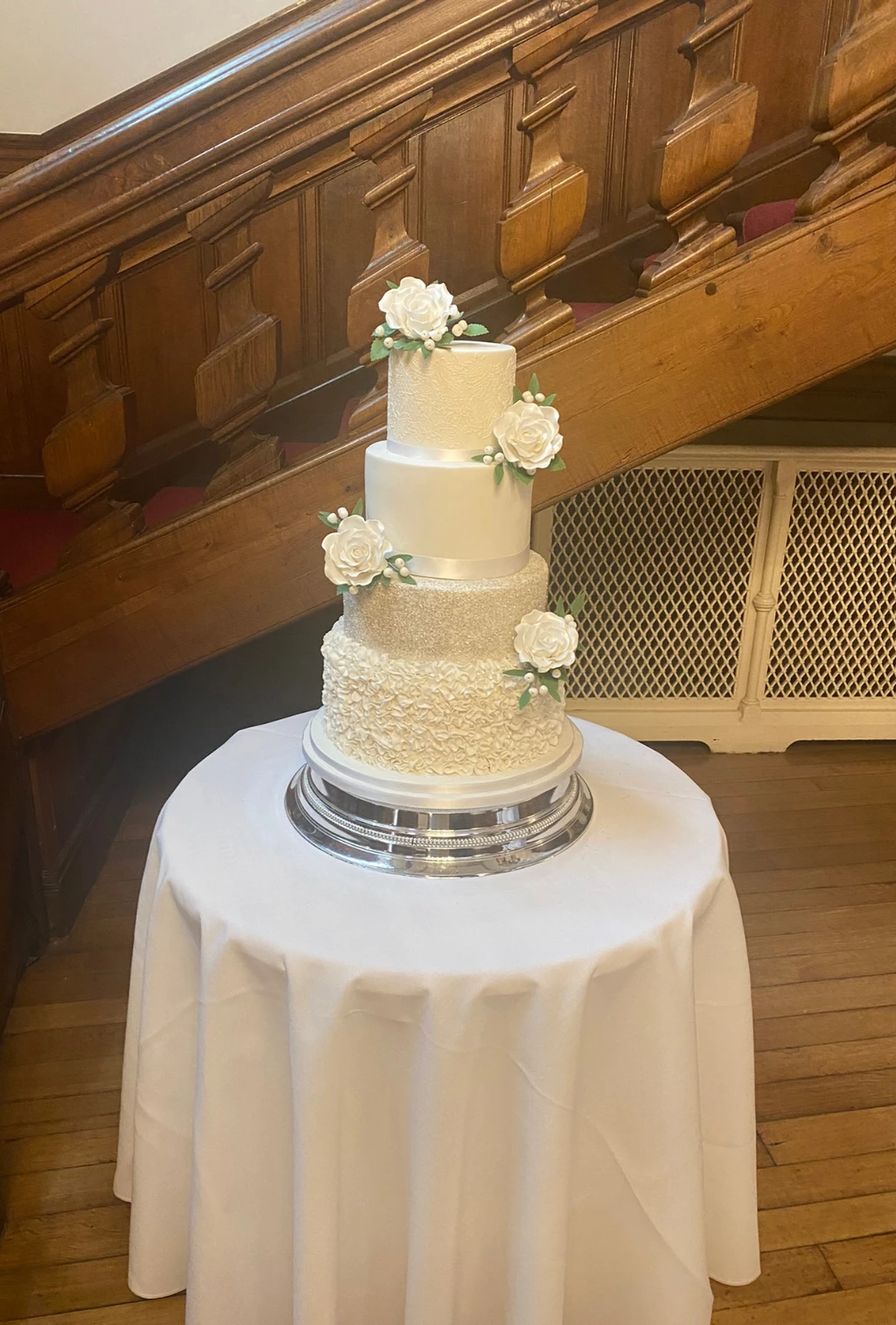 Three-tier ivory cake with piped icing and white flowers