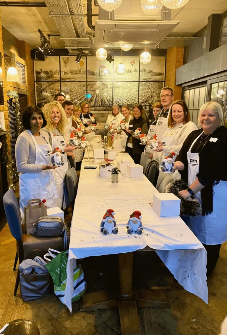 Workshop participants standing beside their decorated cakes